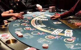 Smartphone app interface showing live roulette table with betting grid, player chat, and balance display